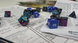 Character sheets with dice on top